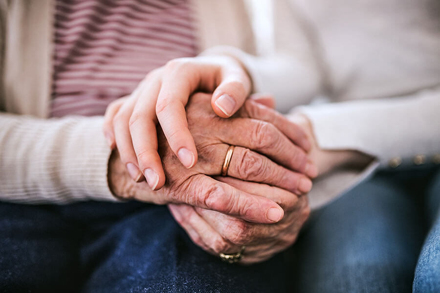 photo of an elderly couple holding hands